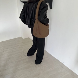 Brown nylon tote bag styled with a leather jacket showing large capacity and soft texture