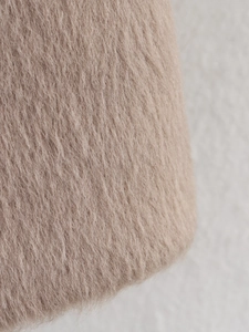 Detailed close-up of high-quality light camel wool blend fabric with soft plush texture