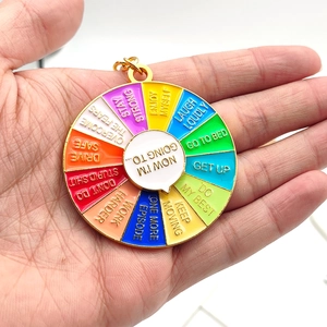 Close-up of a colorful rainbow mood spinning keychain held in hand showing enamel details