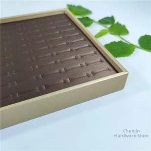 Close-up of golden metal jewelry display tray with brown velvet ring slots for storage
