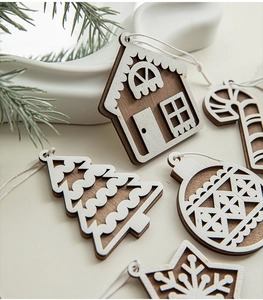 Detailed view of assorted wooden Christmas ornaments with white hollow-out snowflake designs