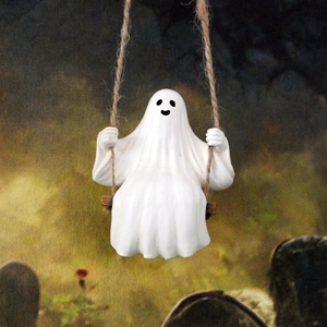 Close-up of cute white ghost figurine on a wood swing with rope for Halloween tree decor