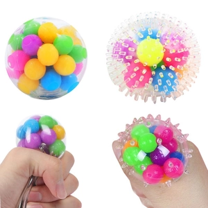 Close-up of four colorful TPR stress relief balls with smooth and spiked textures