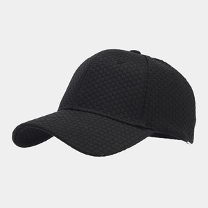 Macro detail of black waffle texture fabric on a vintage style six-panel baseball cap