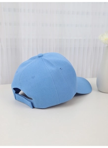 Rear view of blue cotton baseball cap featuring an adjustable velcro strap closure