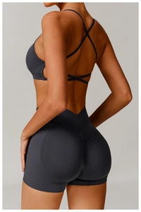 Detailed back view of dark grey seamless yoga set with cross straps and scrunch butt shorts