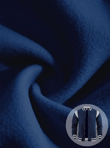 Macro detail of navy blue varsity jacket fabric with striped collar and snap button closure
