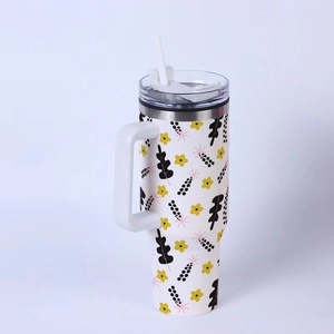 Close-up of 40oz stainless steel tumbler with yellow floral and black leaf patterns