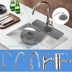 Detail of adjustable snaps on a grey silicone faucet draining mat for kitchen sinks