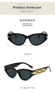 Close-up of black cat-eye sunglasses with gold diamond-shaped metal accents on temples