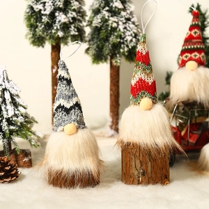 Lighted Christmas gnomes with knitted hats and wooden bases on snowy background