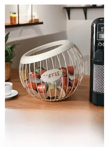 Macro view of cream white metal coffee capsule basket with open design on wood table
