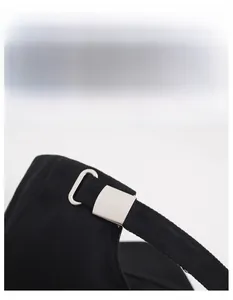 Close-up of black baseball cap showing the adjustable metal buckle and inner sweatband