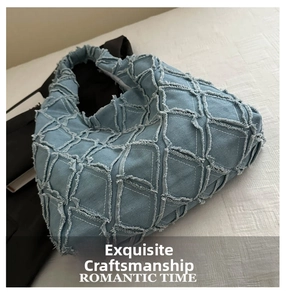 Detail of light blue denim tote bag with raw edges and quilted checkered pattern design