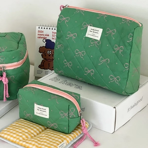 Quilted mint green cosmetic bag set with pink bow pattern and functional zippers