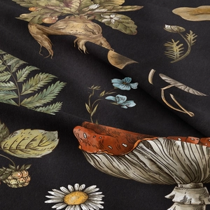 Detail of black fabric featuring vintage mushroom and botanical floral print texture