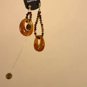 Vintage round resin tiger eye earrings with asymmetrical long metallic tassels