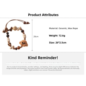 Detail view of woven wax cord bracelet with a brown ceramic teddy dog pendant and beads