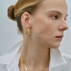 Polished 18k gold plated teardrop earrings with sparkling cubic zirconia on model