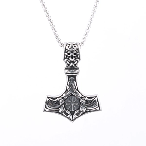 Close-up of vintage silver Thor's Hammer Mjolnir pendant with Nordic runes and steel chain