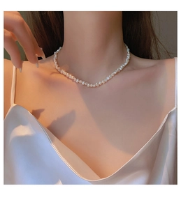 Close-up of elegant baroque freshwater pearl necklace worn by a model on the neck