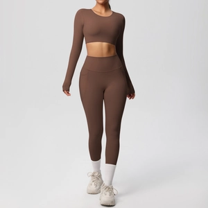 Detail of high-waist yoga leggings with side pockets and long sleeve brown crop top
