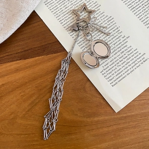 Silver heart locket phone charm with star clasp, metal bow, and long tassel chains