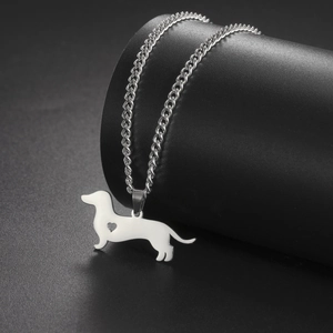 Detail of silver dachshund dog pendant necklace with a heart cutout design