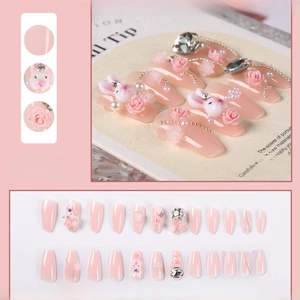 Detailed view of pink press-on nails with 3D bunny, rose, pearl and rhinestone accents