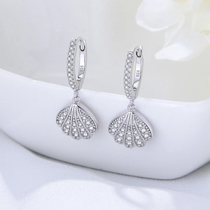 Elegant S925 sterling silver shell earrings with pavé cubic zirconia on white background