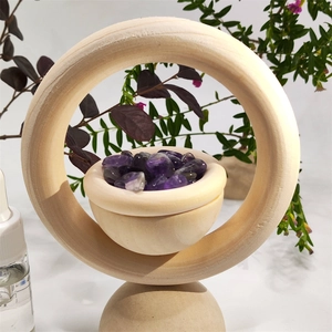 Close-up of a wooden essential oil diffuser featuring a bowl of natural purple crystals