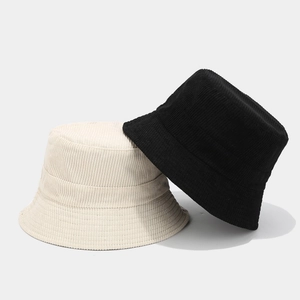 Minimalist corduroy reversible bucket hat in beige and black with clear striped texture