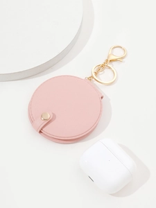 Close-up of pink PU leather mini round mirror keychain with golden snap and metal ring