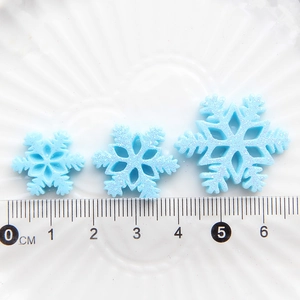 Blue glitter snowflake resin charms in three sizes for DIY crafts and decorations