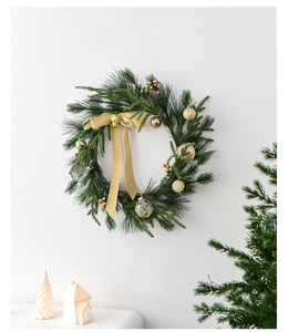 Close-up of a 50cm Nordic Christmas wreath with pine needles, gold ornaments and ribbons