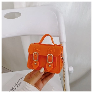 Detailed macro shot of an orange jelly bag with glossy finish and gold metal magnetic buckles