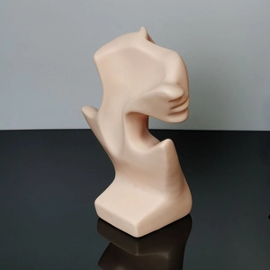 Detail of the minimalist matte skin tone neck display stand for jewelry showing side profile