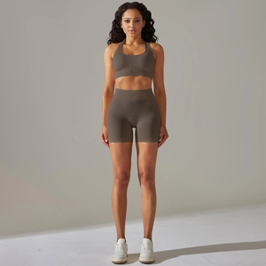Detail of seamless taupe yoga set featuring halter neck bra and high waist shorts