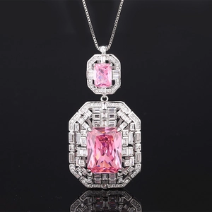 Detailed macro view of pink rectangular crystal pendant with white zircon halo on silver chain