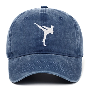 Detail of white martial arts embroidery on washed navy blue denim baseball cap