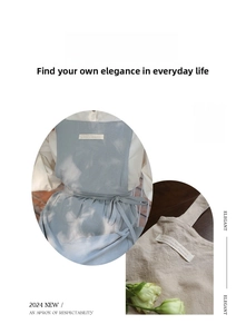 Detail of cotton apron waist ties and woven labels in light blue and beige fabric