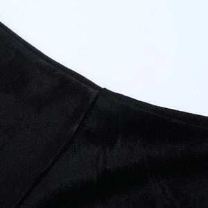 Detail shot of the black velvet fabric showing refined stitching and waist seam texture