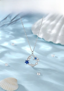 Detail view of S925 sterling silver ocean star pendant with blue zircon on water ripples