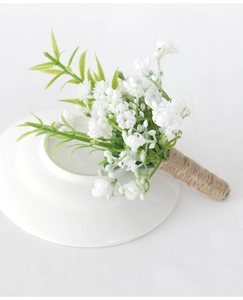 Close-up of white baby's breath boutonniere with natural jute twine wrapping