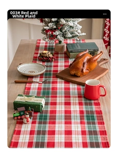 Christmas table runner with red and white plaid pattern and festive dining decorations