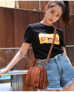 Brown retro crossbody bag shown as a detail view on a shoulder for daily lifestyle