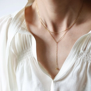 Minimalist double layer Y-shaped gold necklace with a round bead pendant on 18K gold plated steel