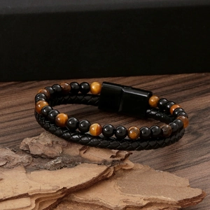 Detailed view of handmade tiger eye stone bracelet with leather braid and magnetic clasp