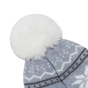 Close-up of grey-blue knit beanie featuring white snowflake patterns and a fluffy pompom