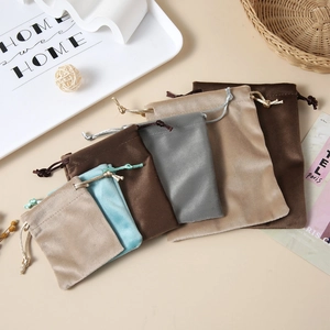 Soft velvet drawstring pouches in various sizes and colors like beige, blue, and brown